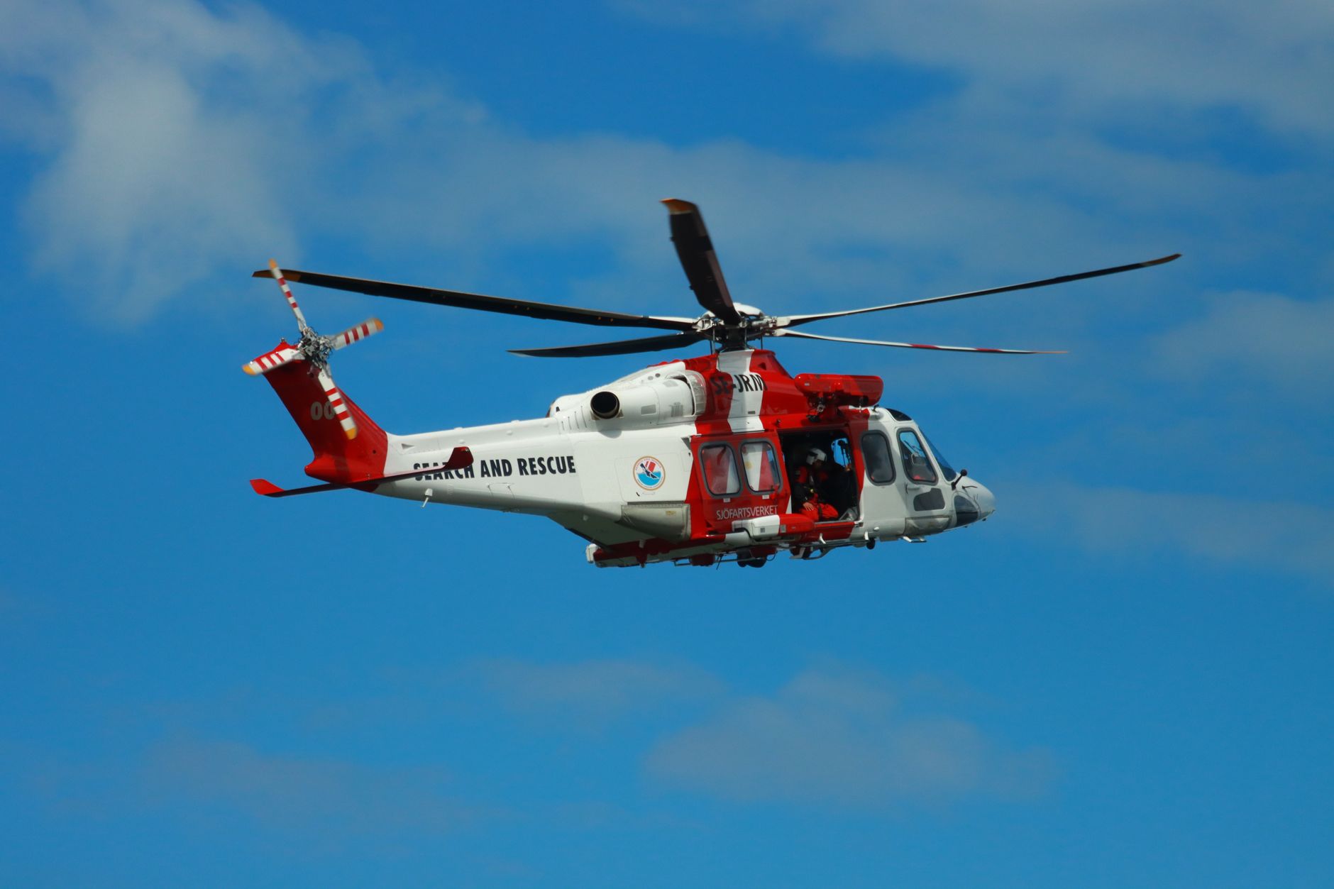 UK coastguard volunteers in hi-vis gear conducting a cliff rescue, illustrating the world of UK coastguard volunteers social media