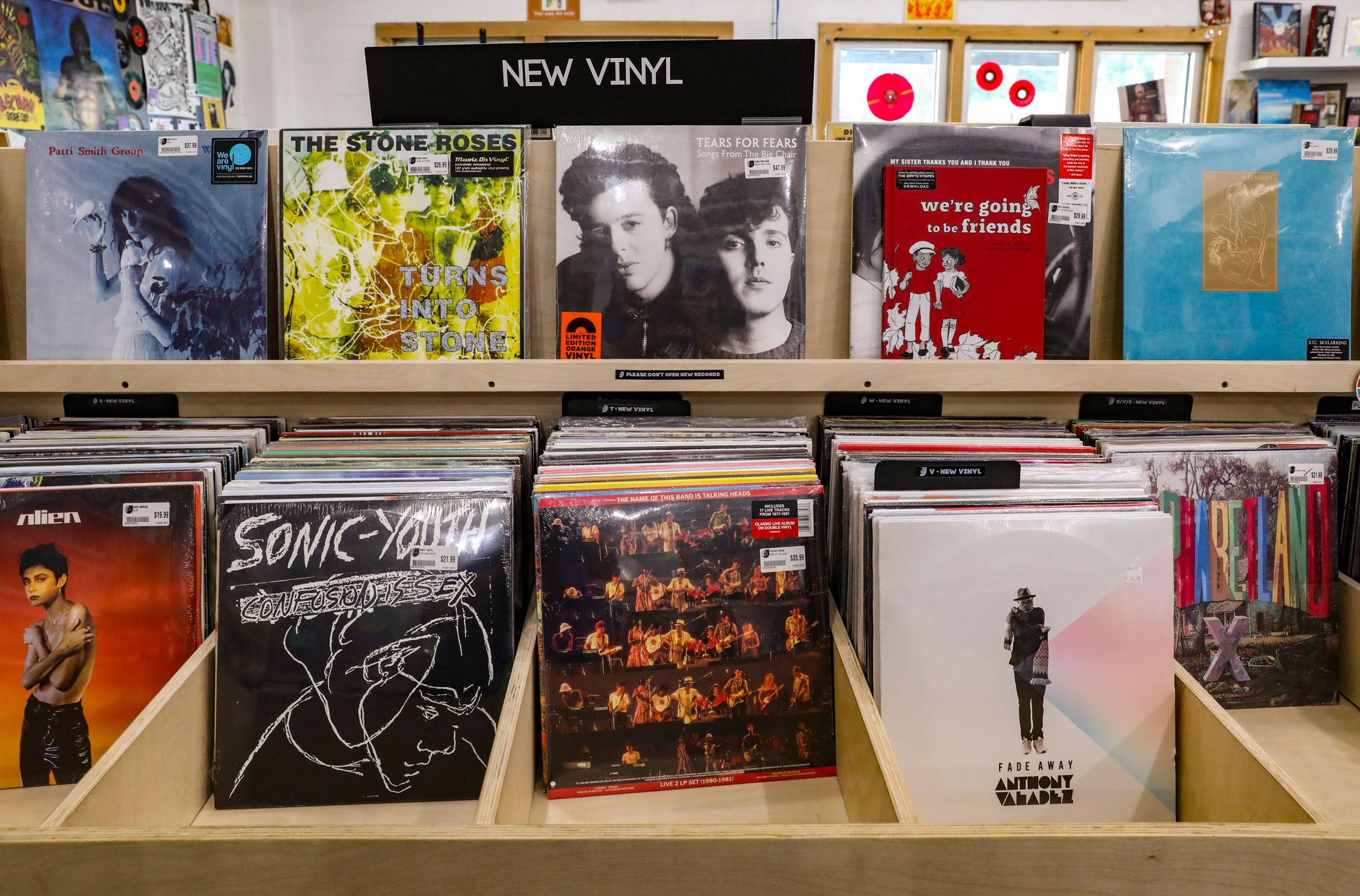 Interior of an independent record shop UK vinyl revival, with shelves of vinyl and a knowledgeable shop owner